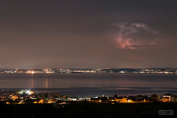 Lightening in the clouds above lake garda